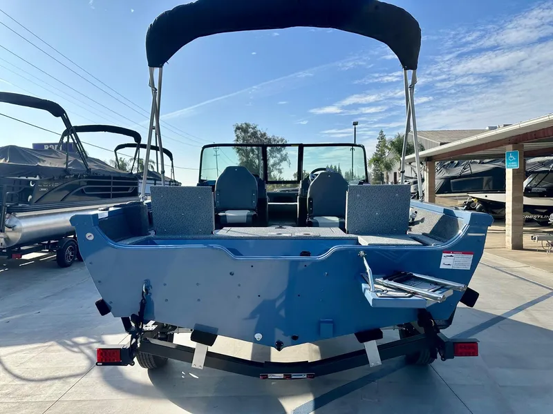 Slide: The Image of 2025 Lowe FS1700 boat with 115HP Mercury engine, blue exterior, parked on trailer. - 10