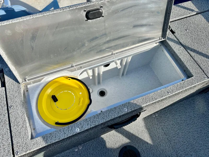 Slide: The Image of Open storage compartment on 2025 Lowe FS1700 boat with yellow lid inside. - 13