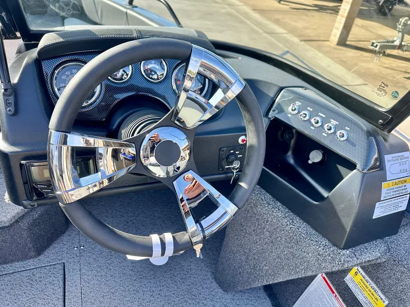 Slide: The Image of 2025 Lowe FS1700 boat dashboard with chrome steering wheel and instrument panel. - 4