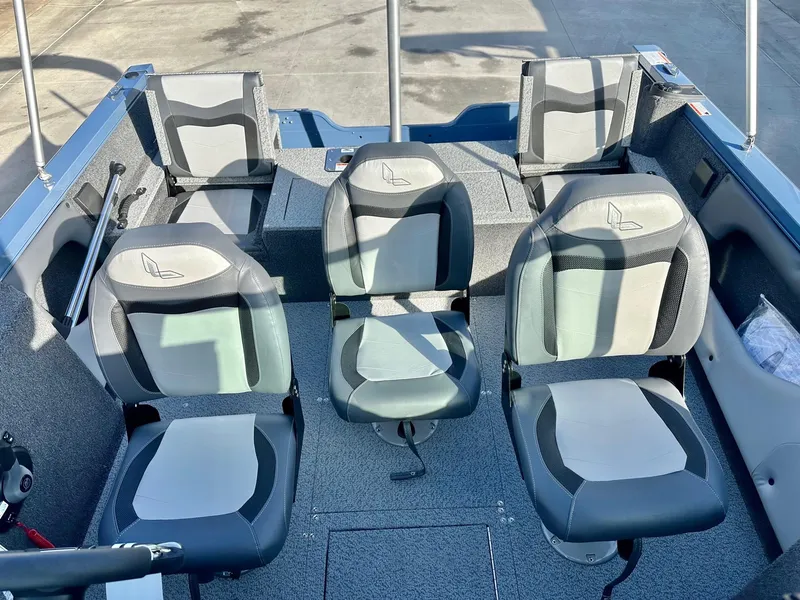 Slide: The Image of 2025 Lowe FS1700 boat interior with four cushioned seats and gray flooring. - 5