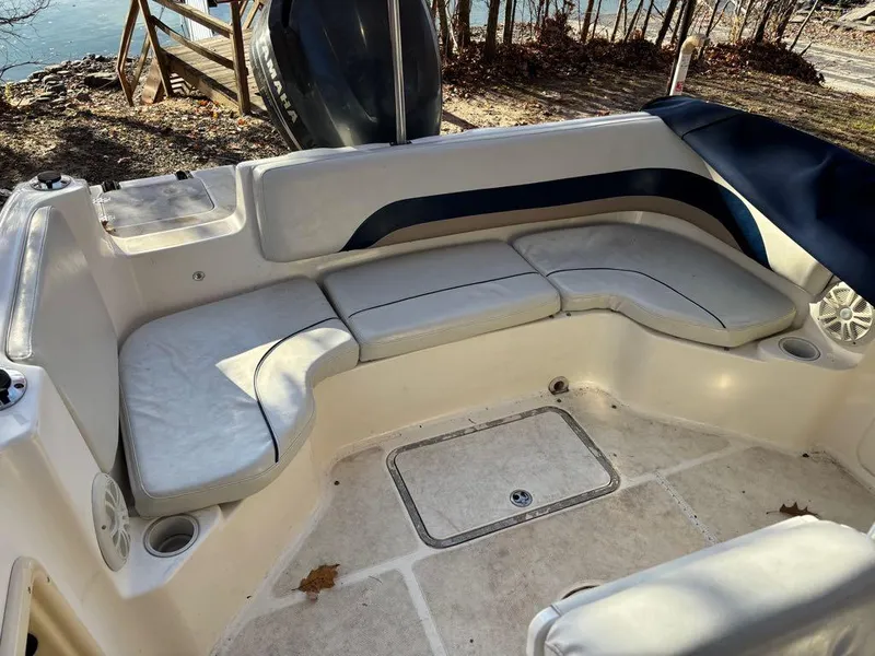 Slide: The Image of 2007 Hurricane Fun Deck GS 231 boat interior with cushioned seating and cup holders. - 11