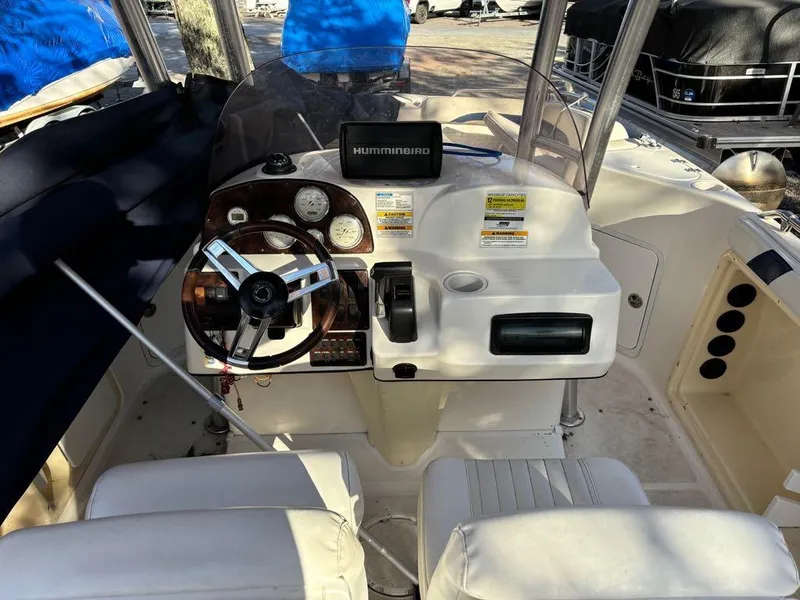 Slide: The Image of 2007 Hurricane Fun Deck GS 231 boat cockpit with steering wheel and controls. - 12