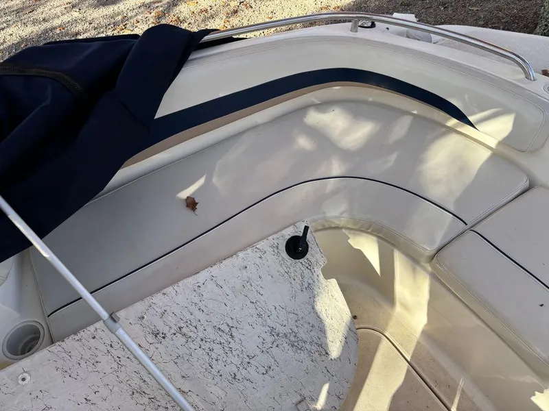 Slide: The Image of 2007 Hurricane Fun Deck GS 231 boat interior with white seating and blue accents. - 13