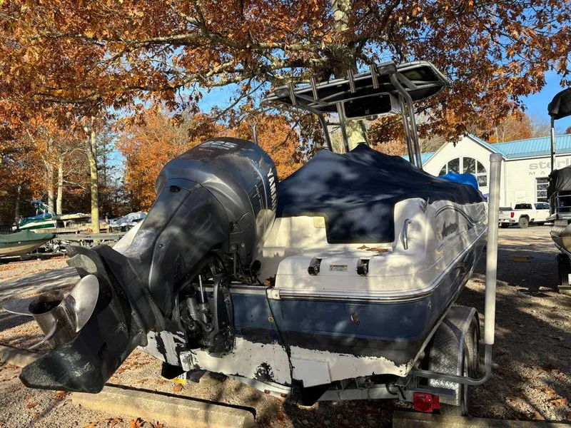 Slide: The Image of 2007 Hurricane Fun Deck GS 231 boat with Yamaha outboard motor, parked under autumn trees. - 14