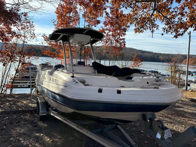 Slide: The Image of 2007 Hurricane Fun Deck GS 231 boat on trailer by autumn lake. - 21