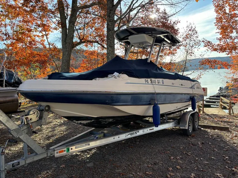 Slide: The Image of 2007 Hurricane Fun Deck GS 231 boat on trailer, autumn trees in background. - 22