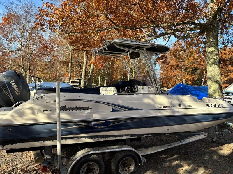 Slide: The Image of 2007 Hurricane Fun Deck GS 231 boat on trailer, surrounded by autumn trees. - 7