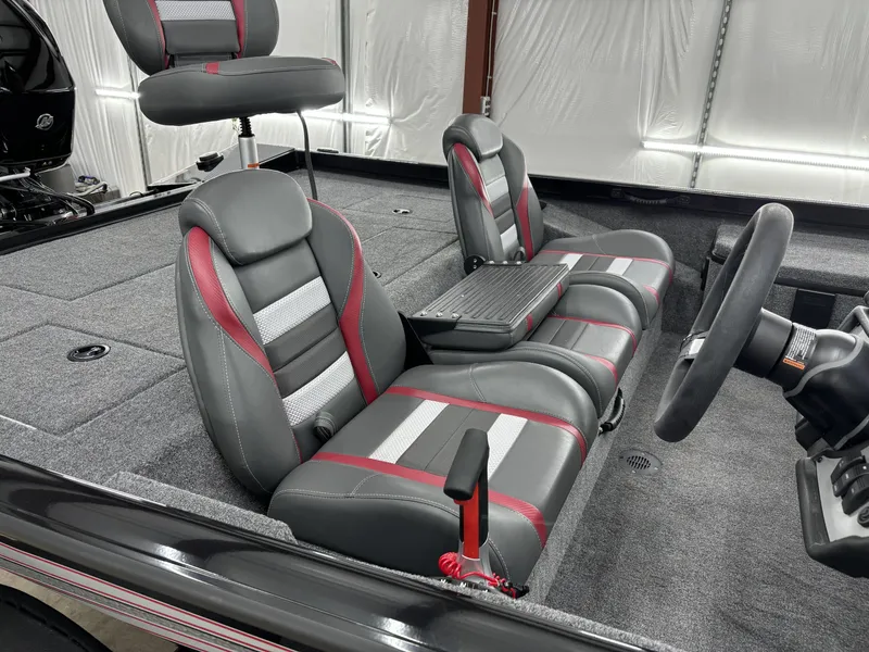 Slide: The Image of 2024 Ranger RT178 boat interior with gray and red seating, steering wheel, and carpeted flooring. - 10