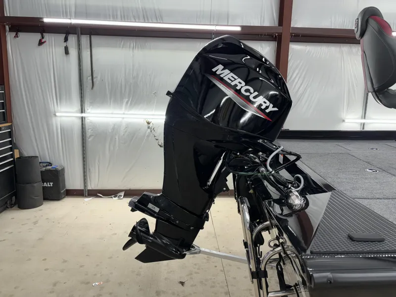 Slide: The Image of 2024 Ranger RT178 boat with Mercury outboard motor in a garage setting. - 13