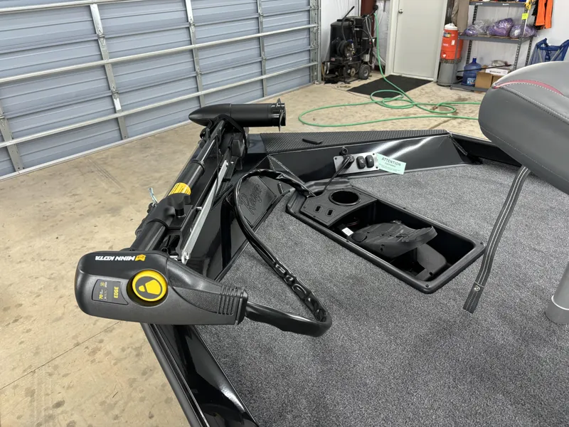 Slide: The Image of 2024 Ranger RT178 boat interior with Minn Kota trolling motor in a garage setting. - 15
