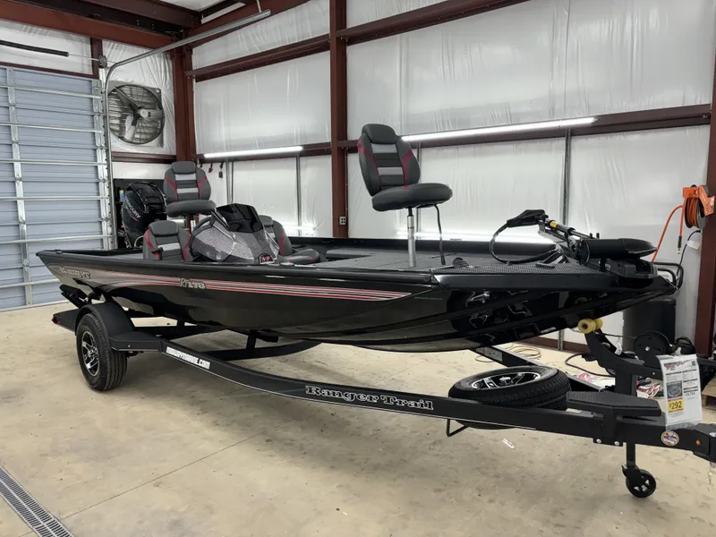Slide: The Image of 2024 Ranger RT178 fishing boat in a garage, featuring sleek black design and modern seating. - 3