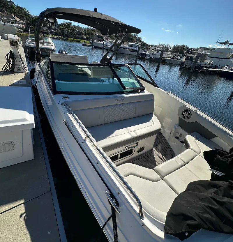 Slide: The Image of 2022 Sea Ray SDX 250 Outboard boat docked at marina, sunny day. - 10