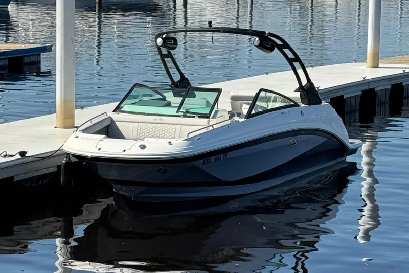 Slide: The Image of 2022 Sea Ray SDX 250 Outboard boat docked on calm water. - 2