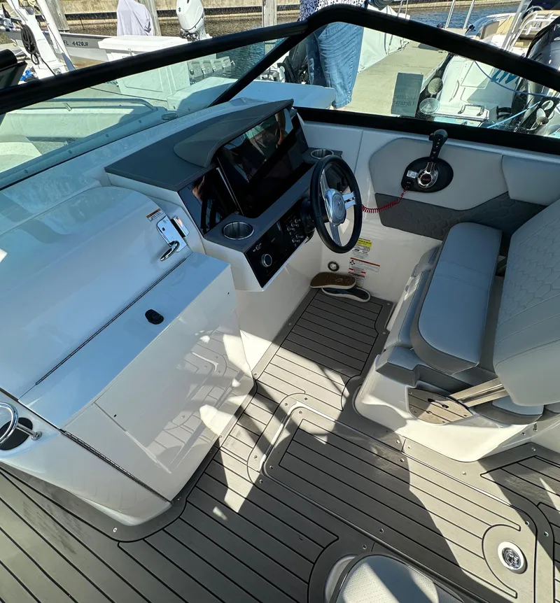 Slide: The Image of 2022 Sea Ray SDX 250 Outboard boat cockpit with modern controls and seating. - 8