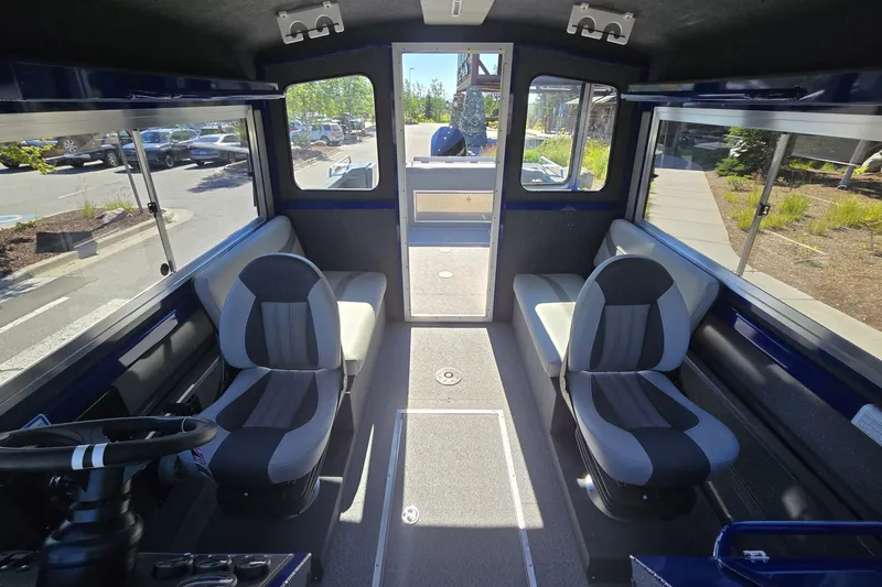 Slide: The Image of Interior of 2024 Spartan 240 Maximus boat with modern seating and panoramic windows. - 36