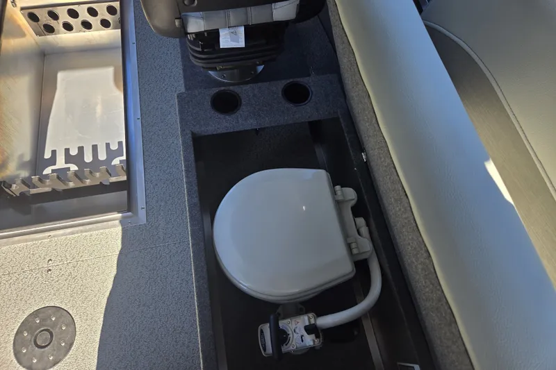 Slide: The Image of 2024 Spartan 240 Maximus boat interior with seating and storage compartments. - 28