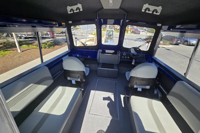 Slide: The Image of Interior of 2024 Spartan 240 Maximus boat with seating and control panel. - 27