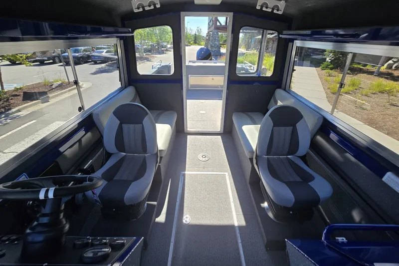 Slide: The Image of Interior of 2024 Spartan 240 Maximus boat with seating and steering wheel. - 37