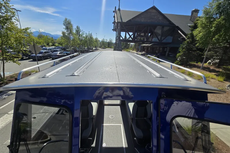 Slide: The Image of 2024 Spartan 240 Maximus vehicle roof view in a scenic parking area. - 35