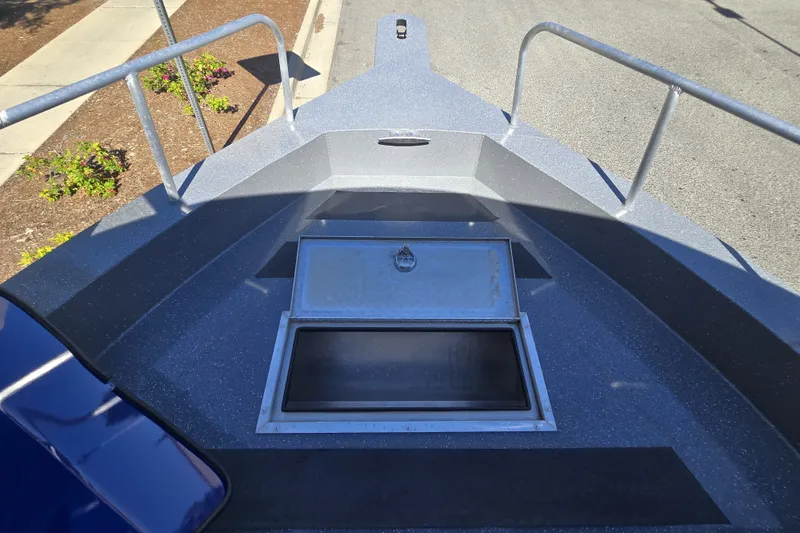Slide: The Image of 2024 Spartan 240 Maximus boat deck with open storage compartment. - 34