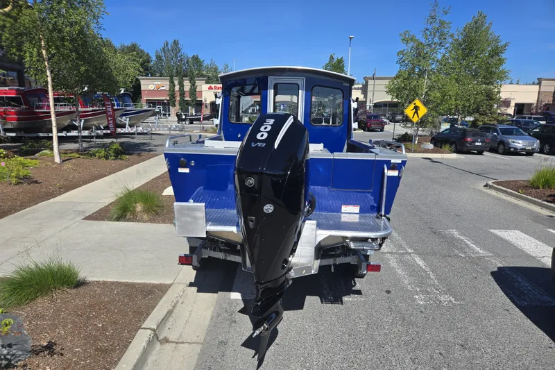 Slide: The Image of 2024 Spartan 240 Maximus boat with powerful V8 engine in a parking lot. - 15