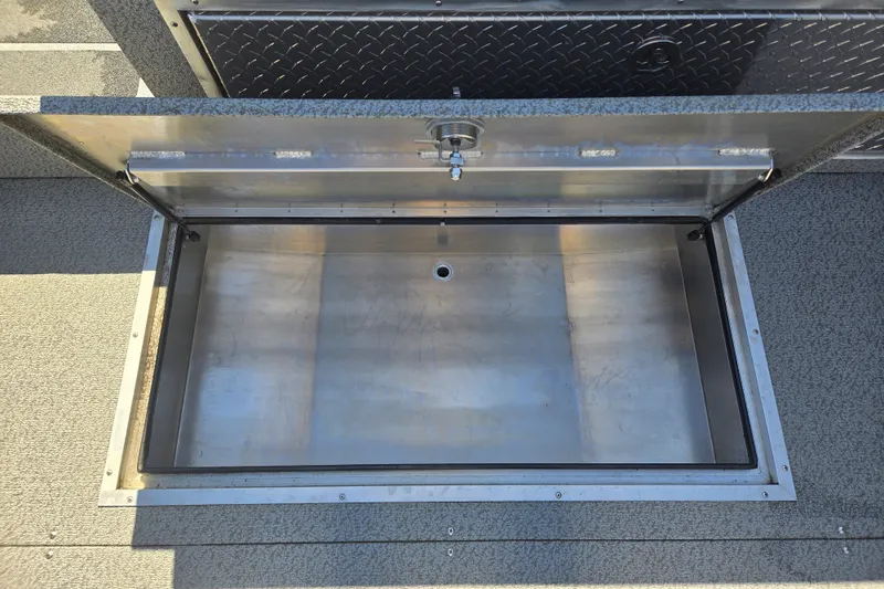 Slide: The Image of Open storage compartment in 2024 Spartan 240 Maximus boat, featuring durable metal construction. - 24