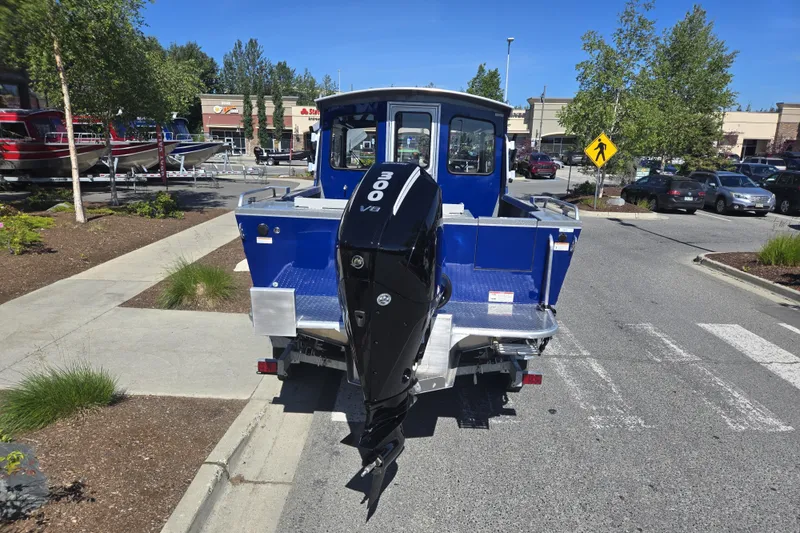 Slide: The Image of 2024 Spartan 240 Maximus boat with 300 V8 engine in a parking lot. - 14