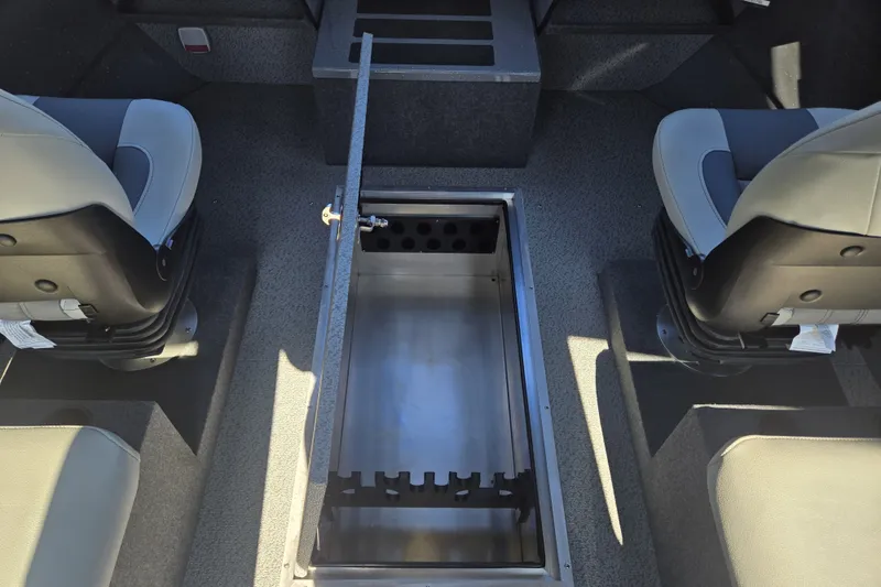 Slide: The Image of 2024 Spartan 240 Maximus interior with open storage compartment between two seats. - 31