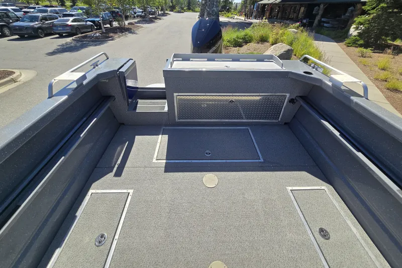 Slide: The Image of 2024 Spartan 240 Maximus boat interior with spacious deck and storage compartments. - 20