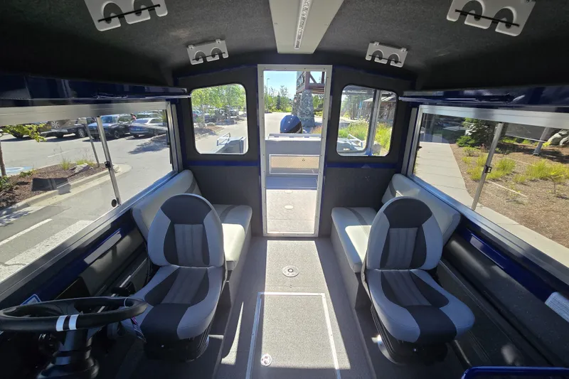 Slide: The Image of Interior of 2024 Spartan 240 Maximus boat with modern seating and panoramic windows. - 38
