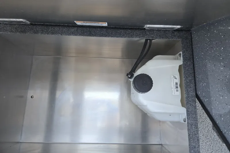 Slide: The Image of Interior compartment of 2024 Spartan 240 Maximus with storage and utility container. - 33