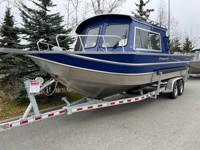 The Image of 2024 Spartan 26 Maximus Pro XL boat on trailer, parked outdoors. - 0