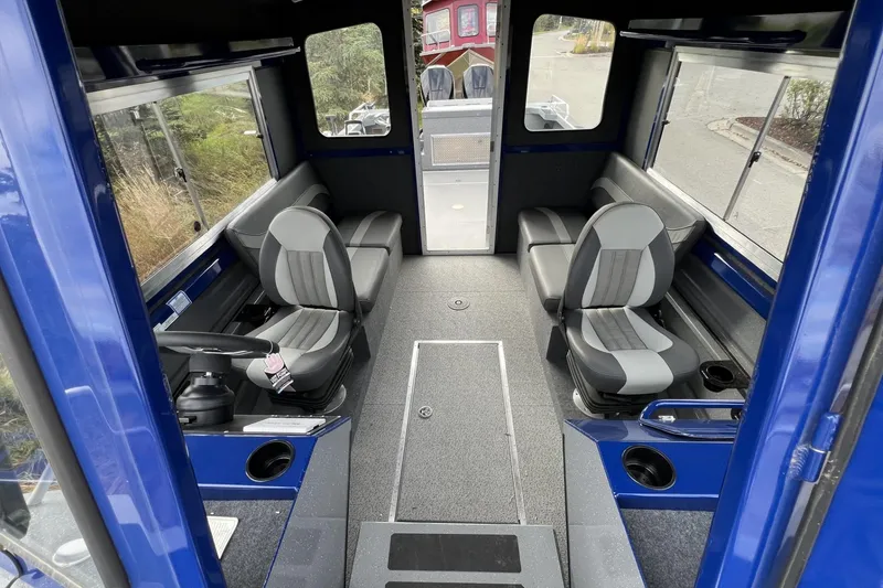 Slide: The Image of Interior of 2024 Spartan 26 Maximus Pro XL boat with seating and steering console. - 26
