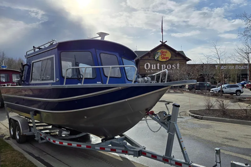 Slide: The Image of 2024 Spartan 26 Maximus Pro XL boat on trailer outside Bass Pro Shops Outpost. - 31