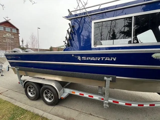 Slide: The Image of 2024 Spartan 26 Maximus Pro XL boat on trailer, blue exterior. - 34