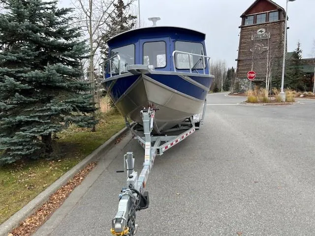 Slide: The Image of 2024 Spartan 26 Maximus Pro XL boat on trailer, featuring a Mercury engine. - 4