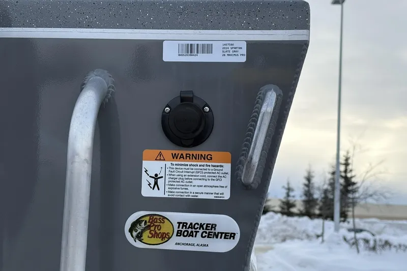 Slide: The Image of 2024 Spartan 26 Maximus Pro XL boat with warning label and Bass Pro Shops sticker. - 12