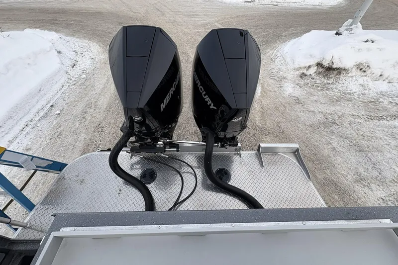 Slide: The Image of 2024 Spartan 26 Maximus Pro XL with dual Mercury outboard motors on snowy terrain. - 13