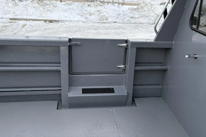 Slide: The Image of 2024 Spartan 26 Maximus Pro XL boat interior with gray textured finish and storage compartments. - 17