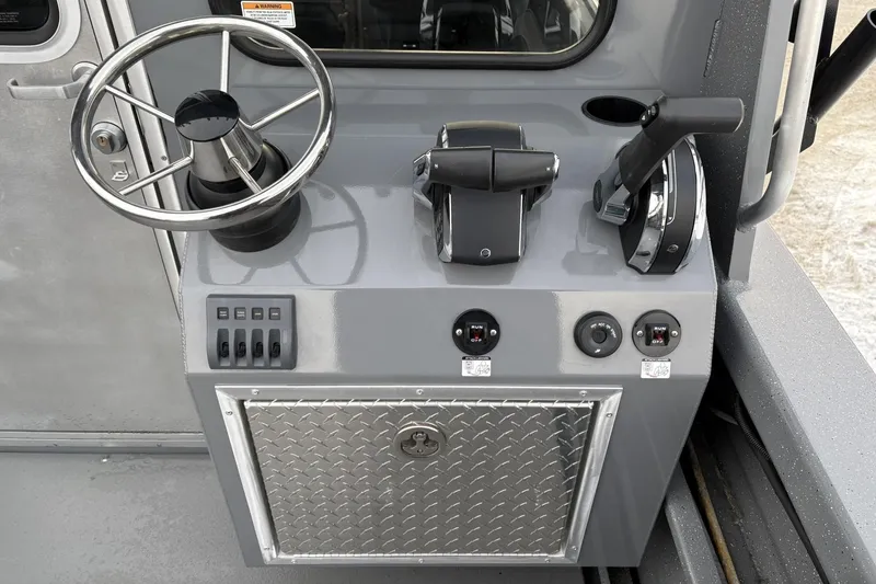 Slide: The Image of 2024 Spartan 26 Maximus Pro XL boat console with steering wheel and controls. - 18
