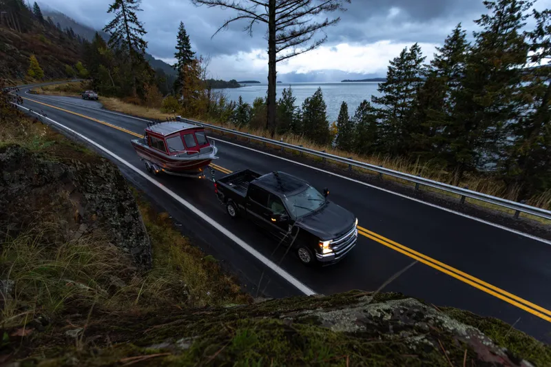 Slide: The Image of 2024 Spartan 26 Maximus Pro XL boat on trailer in snowy landscape. - 2