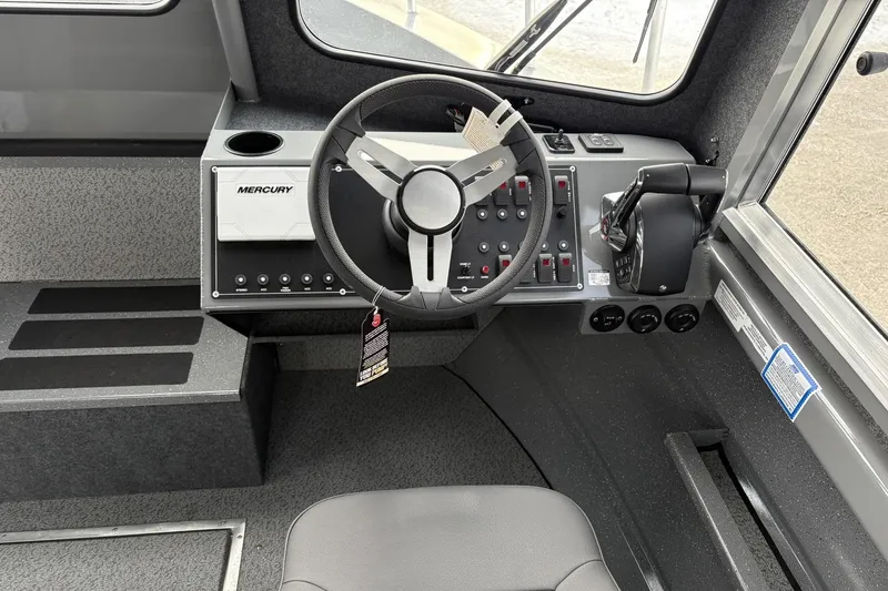 Slide: The Image of 2024 Spartan 26 Maximus Pro XL boat cockpit with Mercury controls and steering wheel. - 20
