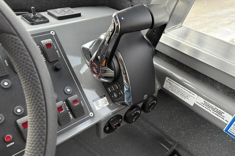 Slide: The Image of Control panel of 2024 Spartan 26 Maximus Pro XL boat with throttle and switches. - 21