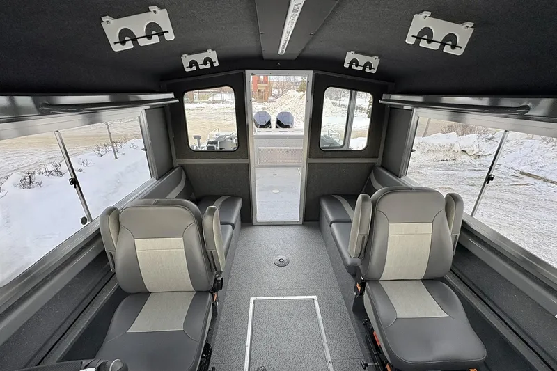 Slide: The Image of Interior of 2024 Spartan 26 Maximus Pro XL boat with seating and windows. - 24