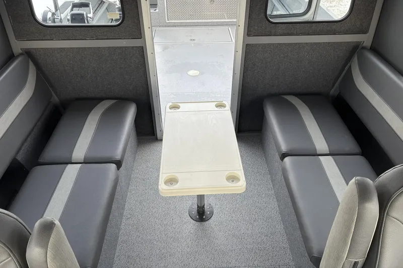 Slide: The Image of 2024 Spartan 26 Maximus Pro XL interior with seating and table setup. - 29