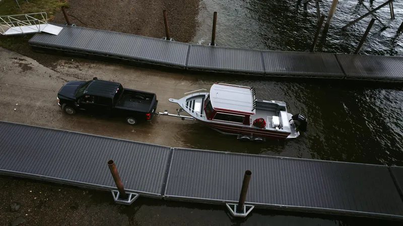 Slide: The Image of 2024 Spartan 26 Maximus Pro XL boat on trailer in snowy landscape. - 3