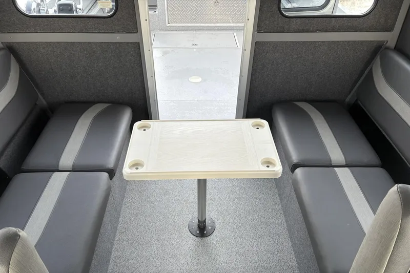 Slide: The Image of Interior of 2024 Spartan 26 Maximus Pro XL with seating and table setup. - 30