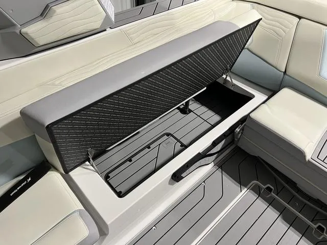 Slide: The Image of 2025 Nautique Super Air Nautique G25 interior storage compartment with sleek seating design. - 12