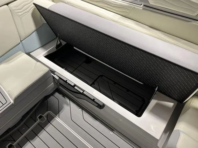 Slide: The Image of 2025 Nautique Super Air Nautique G25 interior storage compartment with open seat. - 14