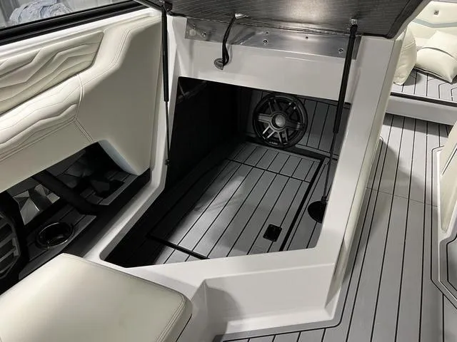 Slide: The Image of 2025 Nautique Super Air Nautique G25 interior with storage compartment and speaker. - 20
